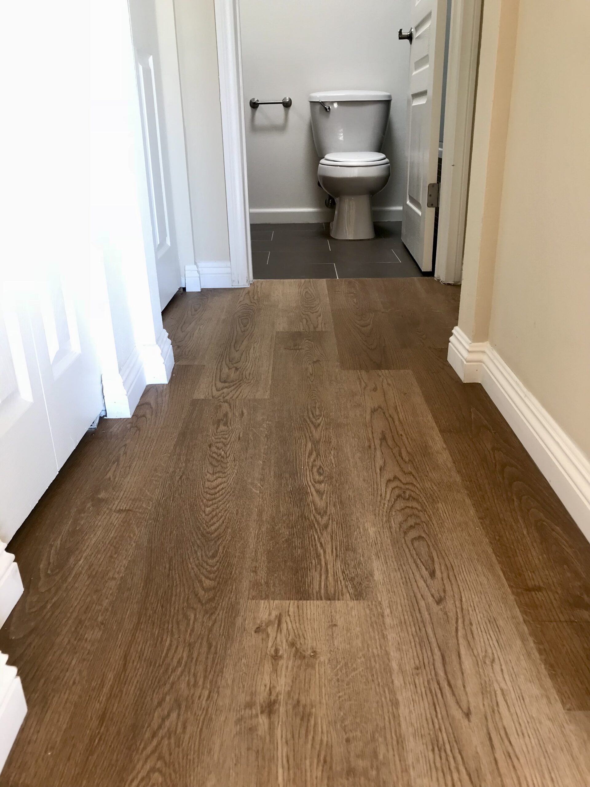 Luxurious Vinyl Plank Floor and Baseboard Installation. Water Proof Flooring.