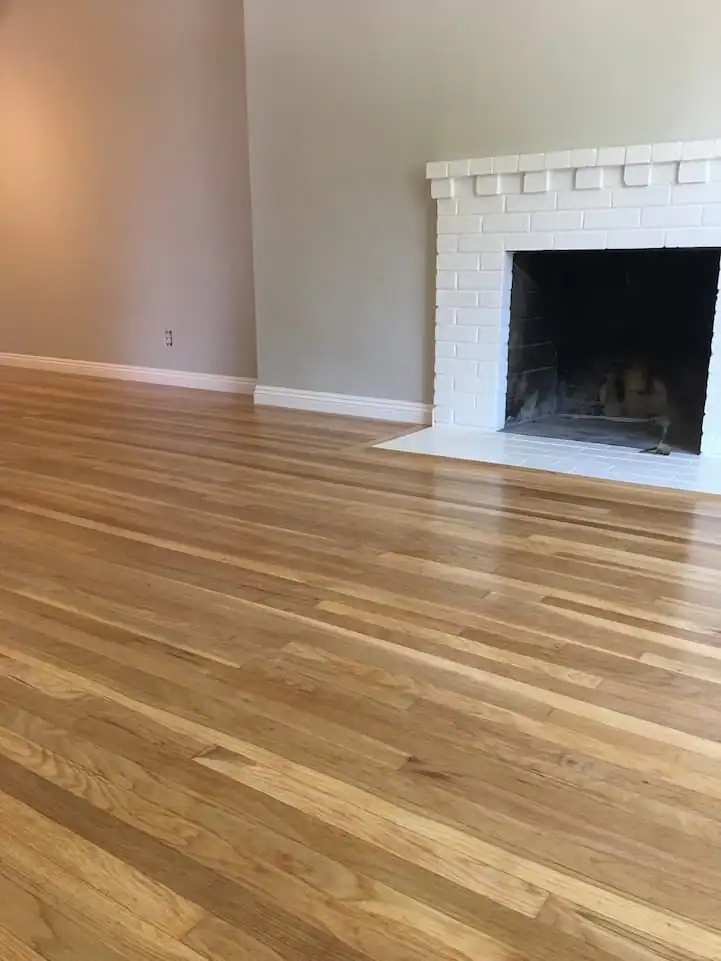 Natural oak hardwood floor refinishing that restores original color, smooth texture, and long-lasting protection through expert sanding.
