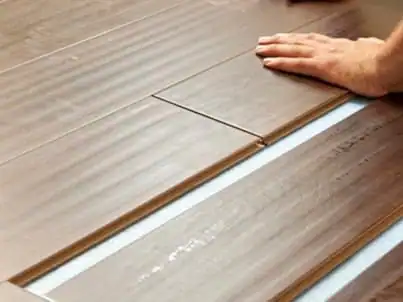 Laminate flooring installation in a Los Angeles home with a clean finished look and underlayment installation for moister protection.