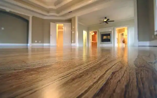 New bedroom hardwood floor installation with sanding and refinishing in Los Angeles, featuring smooth finish, rich wood tone, and expert workmanship.
