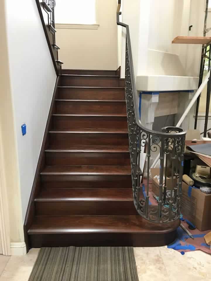 Walnut hardwood stair installation featuring rich dark tones, custom-fitted steps, and professional craftsmanship for a luxury finish.