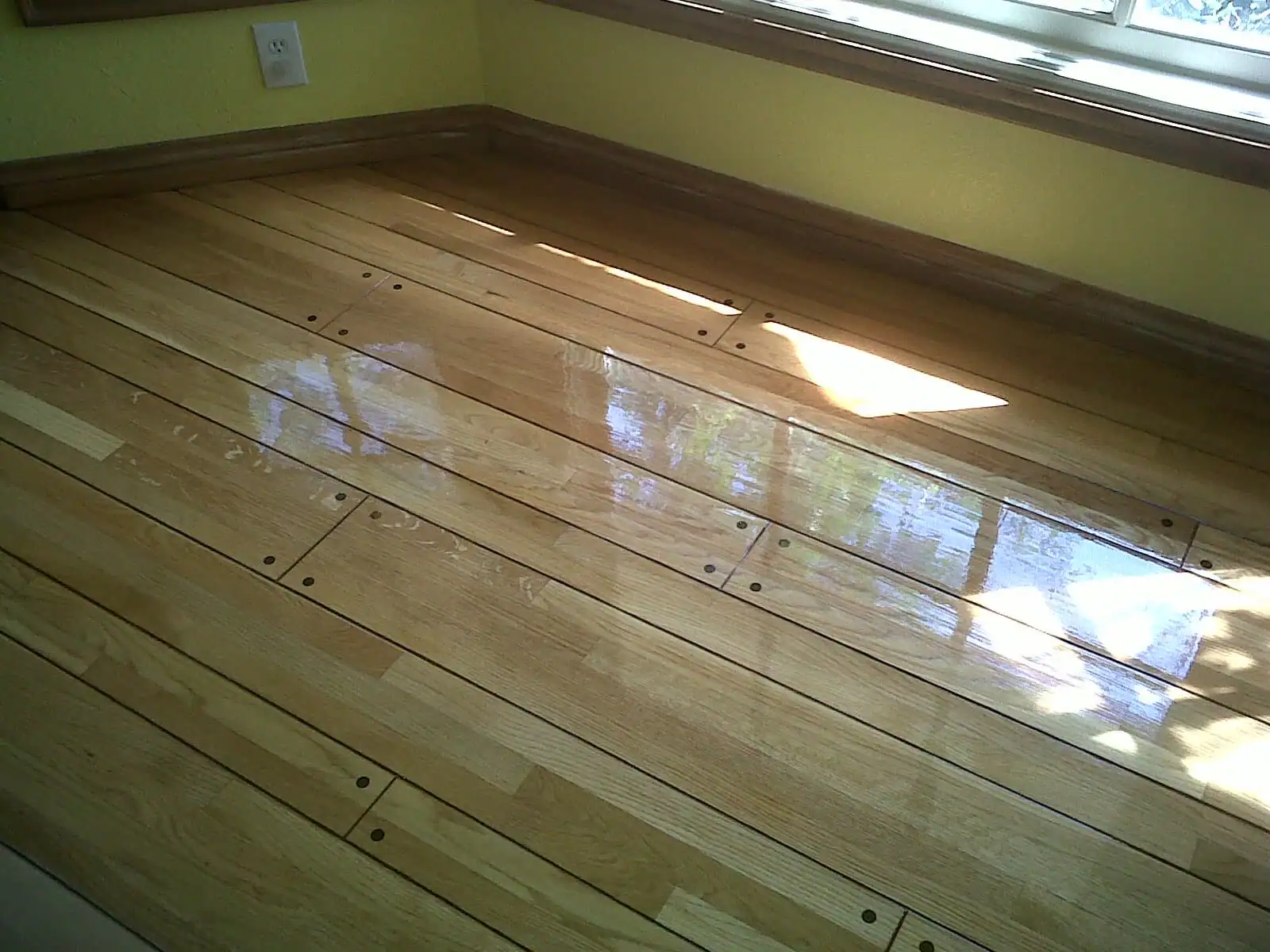 Professional hardwood floor refinishing in Inglewood, CA showing a dustless sanding process on oak floors.